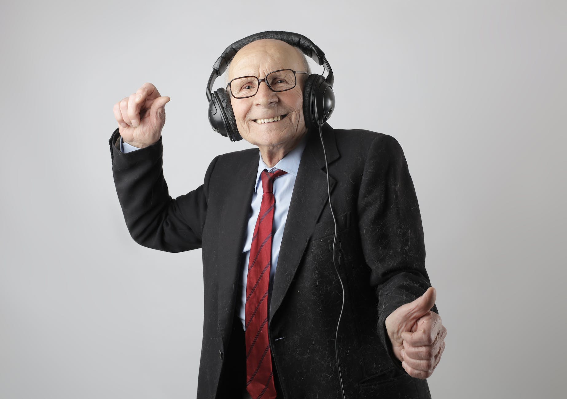 cheerful elderly man listening to music in headphones,Hindi song captions for instagram
